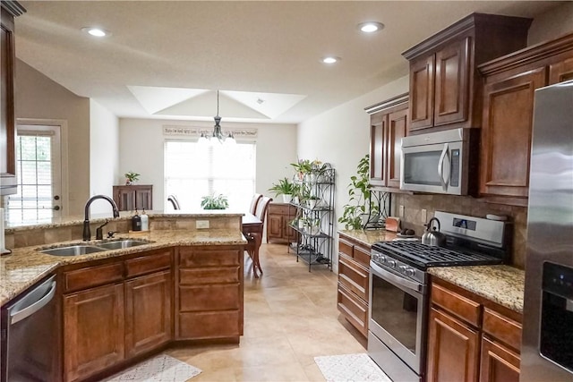 1011 Harvest St, Centerton, AR 72719 - kitchen with stainless steel appliances, recessed lighting, light stone countertops, tasteful backsplash, and a chandelier