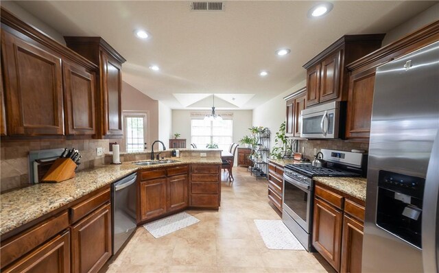 1011 Harvest St, Centerton, AR 72719 - kitchen featuring stainless steel appliances, recessed lighting, tasteful backsplash, a peninsula, and light stone counters