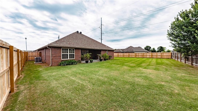 1011 Harvest St, Centerton, AR 72719 - rear view of property featuring brick siding, a fenced backyard, and a shingled roof