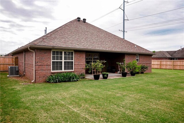 1011 Harvest St, Centerton, AR 72719 - back of property with brick siding, a shingled roof, and a patio