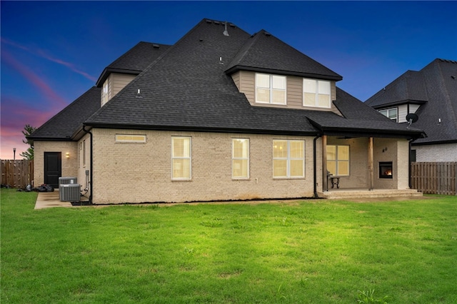 1408 SW Breeze Ct, Bentonville, AR 72713 - rear view of property featuring a patio area, central AC, a shingled roof, and brick siding