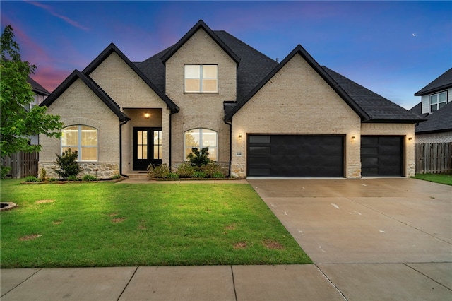 1408 SW Breeze Ct, Bentonville, AR 72713 - french country inspired facade with concrete driveway, an attached garage, brick siding, and stone siding