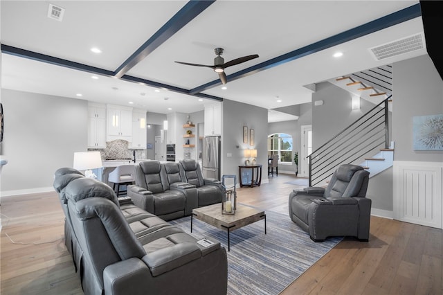 1408 SW Breeze Ct, Bentonville, AR 72713 - living area with ceiling fan, light wood finished floors, beamed ceiling, stairway, and recessed lighting