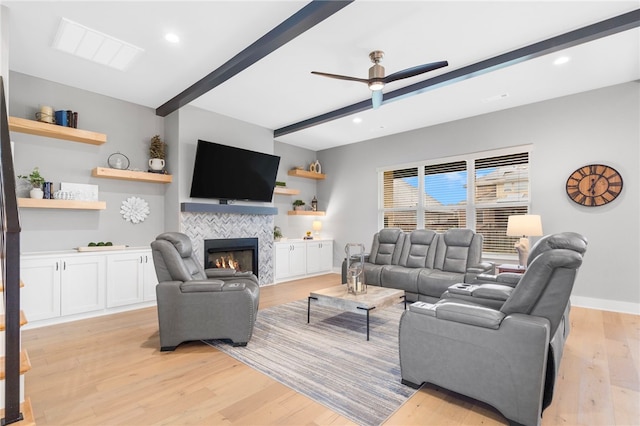 1408 SW Breeze Ct, Bentonville, AR 72713 - living room featuring beamed ceiling, ceiling fan, a fireplace, light wood-style flooring, and recessed lighting