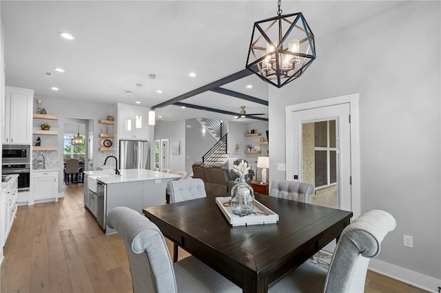 1408 SW Breeze Ct, Bentonville, AR 72713 - dining space with stairs, recessed lighting, light wood-style flooring, a chandelier, and baseboards