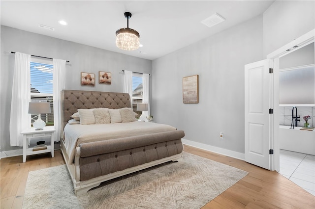 1408 SW Breeze Ct, Bentonville, AR 72713 - bedroom with multiple windows, light wood-style floors, a chandelier, and recessed lighting