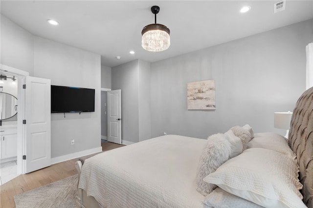 1408 SW Breeze Ct, Bentonville, AR 72713 - bedroom featuring a chandelier, light wood-type flooring, recessed lighting, and baseboards