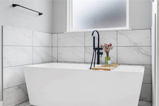 1408 SW Breeze Ct, Bentonville, AR 72713 - bathroom featuring a soaking tub and tile walls