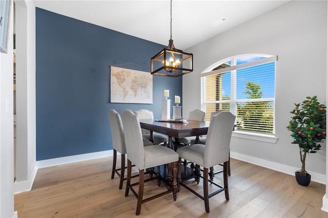 1408 SW Breeze Ct, Bentonville, AR 72713 - dining room featuring light wood-type flooring, a chandelier, and baseboards