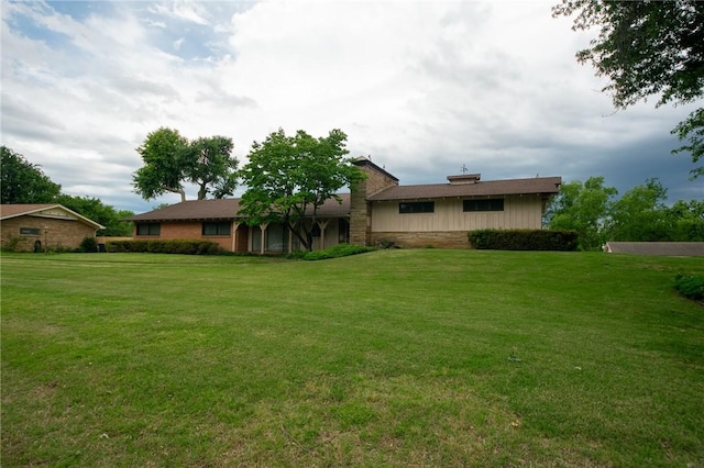 1617 Ranch Dr, Springdale, AR 72762 - rear view of property with a lawn and stone siding