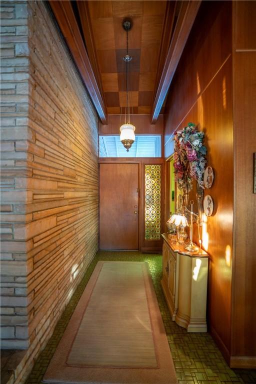 1617 Ranch Dr, Springdale, AR 72762 - hallway with wooden walls, wooden ceiling, and a chandelier