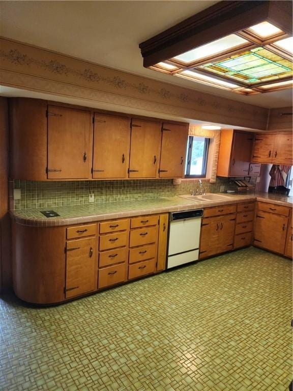 1617 Ranch Dr, Springdale, AR 72762 - kitchen featuring white dishwasher, a sink, backsplash, light floors, and tile counters
