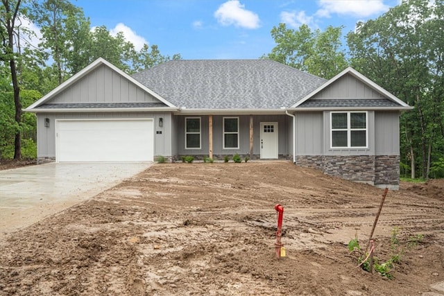 7 Mcginnis Ln, Bella Vista, AR 72715 - view of front of property featuring driveway, stone siding, a garage, a shingled roof, and covered porch