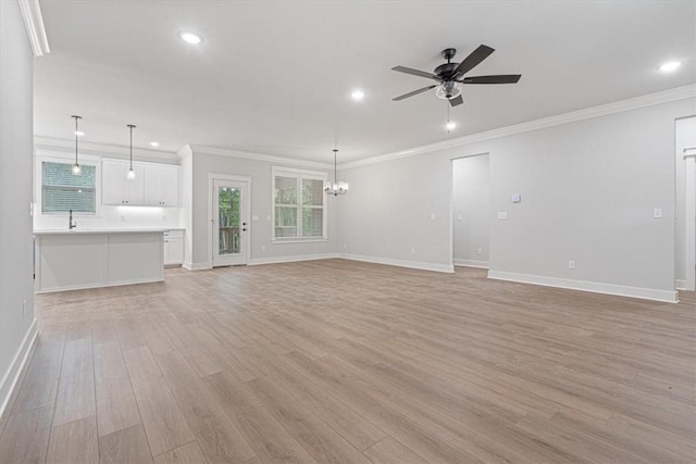 7 Mcginnis Ln, Bella Vista, AR 72715 - unfurnished living room with light wood-type flooring, a ceiling fan, recessed lighting, baseboards, and crown molding