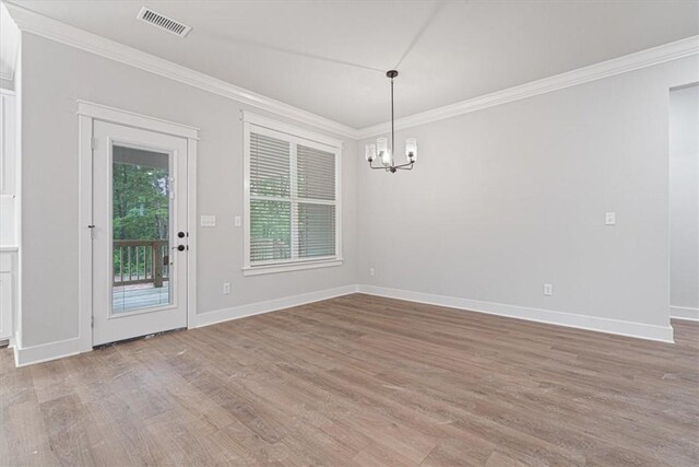7 Mcginnis Ln, Bella Vista, AR 72715 - unfurnished dining area with ornamental molding, a chandelier, wood finished floors, and baseboards