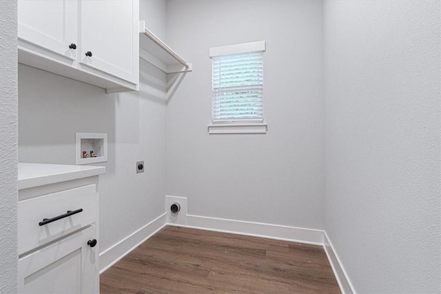 7 Mcginnis Ln, Bella Vista, AR 72715 - laundry area featuring hookup for a washing machine, hookup for an electric dryer, dark wood-type flooring, cabinet space, and baseboards