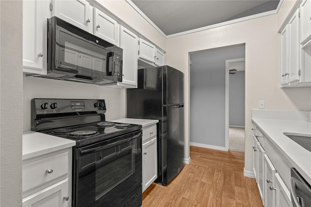 1137 E Township St, Fayetteville, AR 72703 - kitchen with black appliances, light countertops, white cabinetry, and crown molding