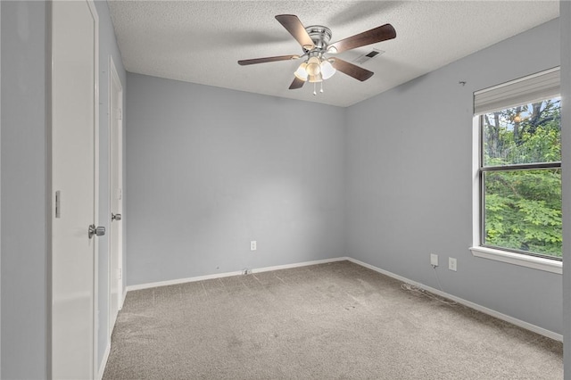 1137 E Township St, Fayetteville, AR 72703 - spare room with carpet floors, a ceiling fan, a textured ceiling, and baseboards