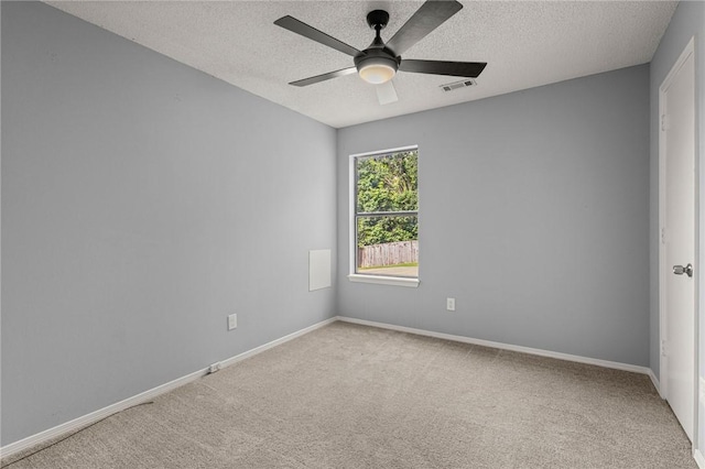 1137 E Township St, Fayetteville, AR 72703 - spare room with carpet flooring, a textured ceiling, ceiling fan, and baseboards