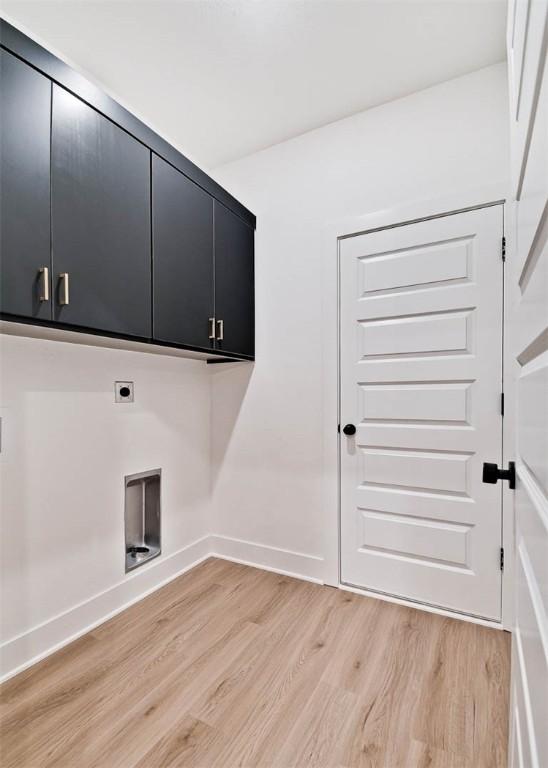 1 Consett Ln, Bella Vista, AR 72714 - laundry area with cabinet space, light wood-style flooring, electric dryer hookup, and baseboards