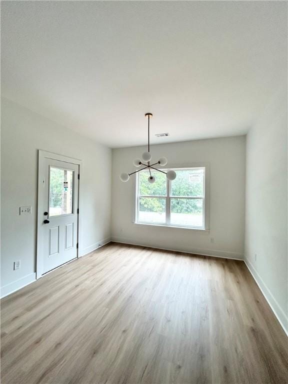1 Consett Ln, Bella Vista, AR 72714 - unfurnished dining area with a chandelier, healthy amount of natural light, wood finished floors, and baseboards