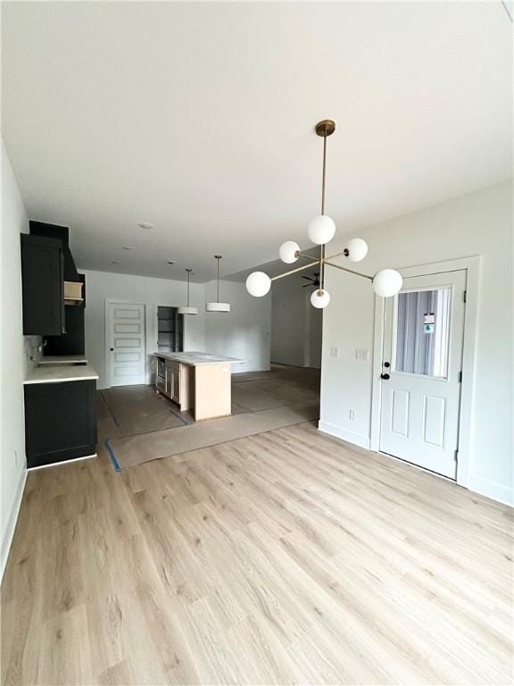 1 Consett Ln, Bella Vista, AR 72714 - unfurnished living room featuring light wood-style flooring and baseboards
