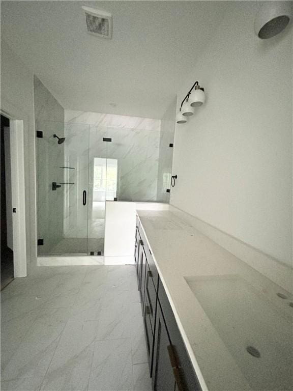 1 Consett Ln, Bella Vista, AR 72714 - bathroom featuring vanity, marble look tile flooring, and a shower stall