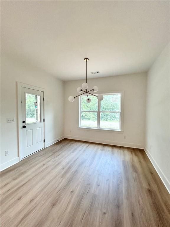 1 Consett Ln, Bella Vista, AR 72714 - unfurnished dining area featuring a chandelier and wood finished floors
