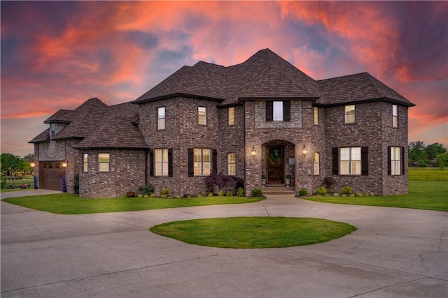 14453 Merritt Dr, Pea Ridge, AR 72751 - french provincial home with curved driveway, brick siding, a yard, and a garage