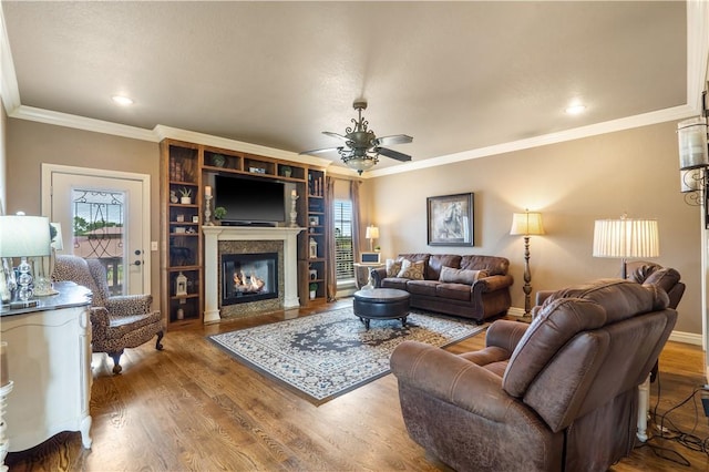 14453 Merritt Dr, Pea Ridge, AR 72751 - living area with a ceiling fan, ornamental molding, a fireplace, plenty of natural light, and wood finished floors