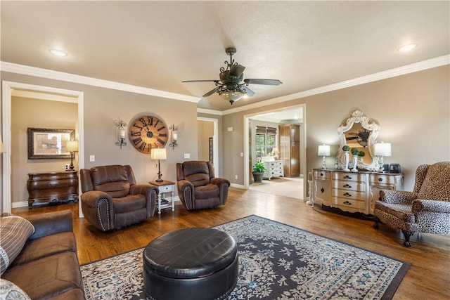 14453 Merritt Dr, Pea Ridge, AR 72751 - living room with wood finished floors, ceiling fan, baseboards, and crown molding