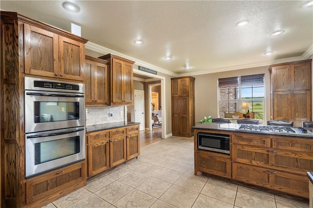 14453 Merritt Dr, Pea Ridge, AR 72751 - kitchen with stainless steel appliances, ornamental molding, decorative backsplash, light tile patterned flooring, and a textured ceiling