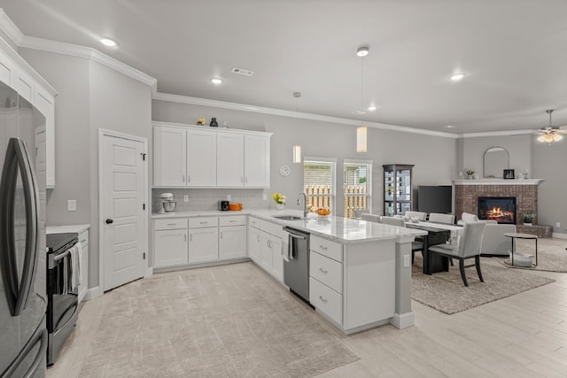 1431 Ari Ave, Centerton, AR 72719 - kitchen featuring a sink, stainless steel appliances, a peninsula, white cabinetry, and decorative backsplash