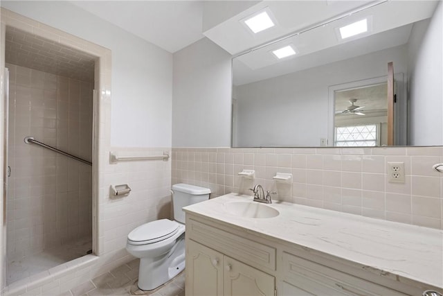 711 W 18th Ter, Russellville, AR 72801 - full bath with vanity, a stall shower, toilet, tile walls, and wainscoting