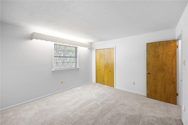 711 W 18th Ter, Russellville, AR 72801 - unfurnished bedroom featuring carpet flooring, a closet, and baseboards