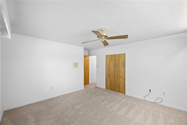 711 W 18th Ter, Russellville, AR 72801 - unfurnished bedroom featuring carpet floors, a closet, ceiling fan, and baseboards