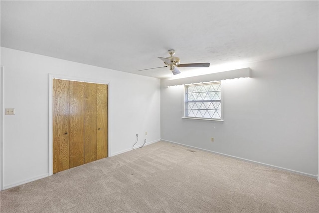 711 W 18th Ter, Russellville, AR 72801 - unfurnished bedroom with carpet flooring, baseboards, a closet, and a ceiling fan