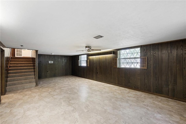711 W 18th Ter, Russellville, AR 72801 - below grade area featuring wooden walls, stairway, and ceiling fan