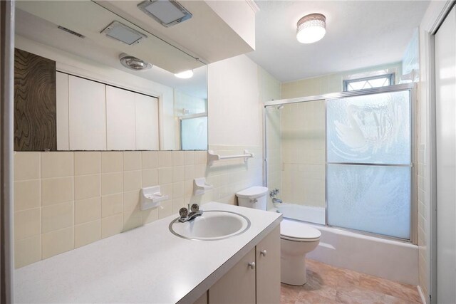 711 W 18th Ter, Russellville, AR 72801 - bathroom with toilet, vanity, and enclosed tub / shower combo