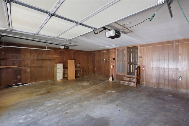 711 W 18th Ter, Russellville, AR 72801 - garage featuring wood walls and a garage door opener