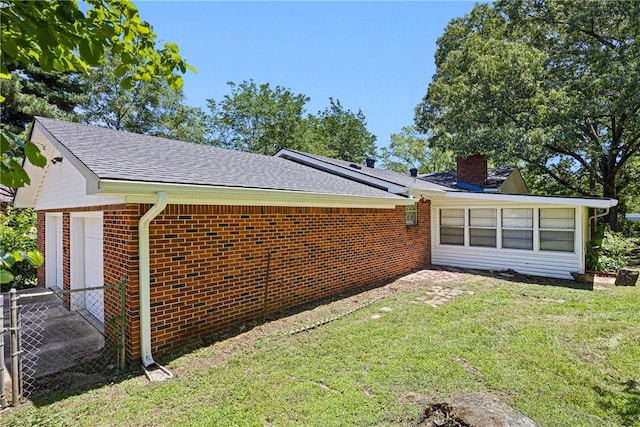 711 W 18th Ter, Russellville, AR 72801 - view of property exterior with brick siding, a chimney, a shingled roof, and a garage