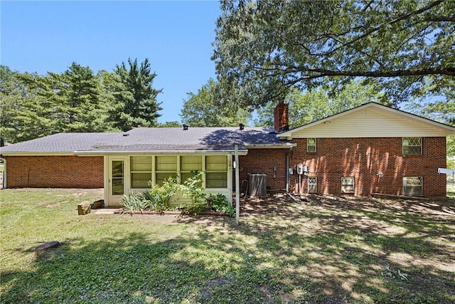 711 W 18th Ter, Russellville, AR 72801 - rear view of property with brick siding, a chimney, a yard, and a sunroom