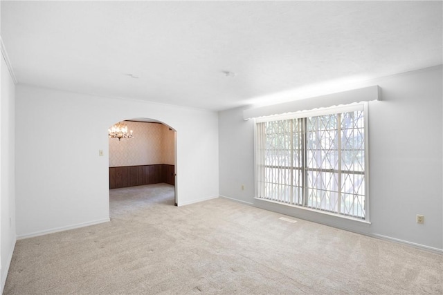 711 W 18th Ter, Russellville, AR 72801 - carpeted empty room featuring arched walkways, a chandelier, and baseboards