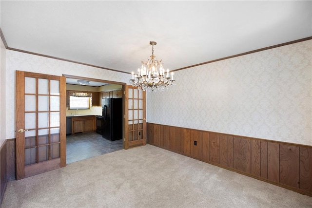 711 W 18th Ter, Russellville, AR 72801 - carpeted empty room with french doors, a wainscoted wall, a sink, crown molding, and wallpapered walls