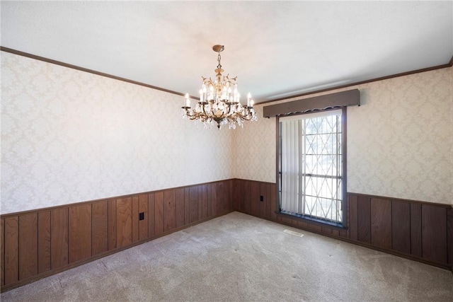 711 W 18th Ter, Russellville, AR 72801 - spare room featuring a wainscoted wall, wallpapered walls, a chandelier, wooden walls, and ornamental molding