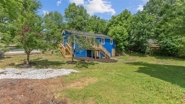 1580 Jones Ln, Pea Ridge, AR 72751 - rear view of house with stairway, a yard, and a wooden deck