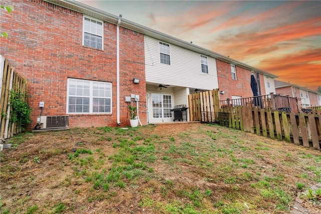 904 S Lafayette St, Rogers, AR 72758 - rear view of property with brick siding, a ceiling fan, a fenced backyard, and central AC unit