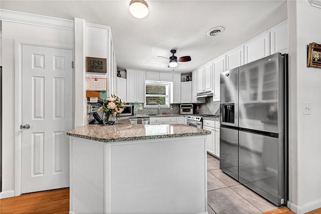 1330 S Baldwin Ave, Fayetteville, AR 72701 - kitchen with appliances with stainless steel finishes, white cabinetry, and a peninsula