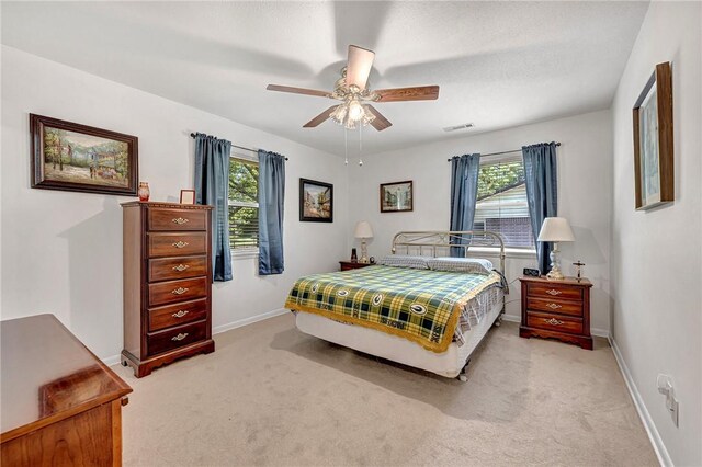 1330 S Baldwin Ave, Fayetteville, AR 72701 - bedroom featuring light carpet, multiple windows, baseboards, and a ceiling fan