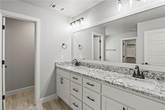 1440 Amber Way, Centerton, AR 72719 - bathroom featuring double vanity and baseboards